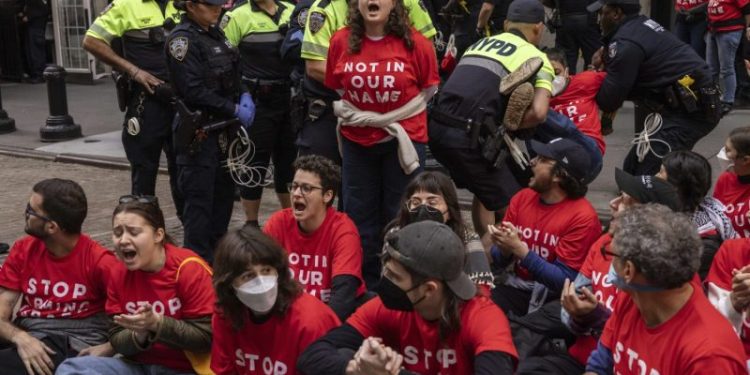 Protesters stage sit-in outside New York Stock Exchange to spotlight Gaza attacks